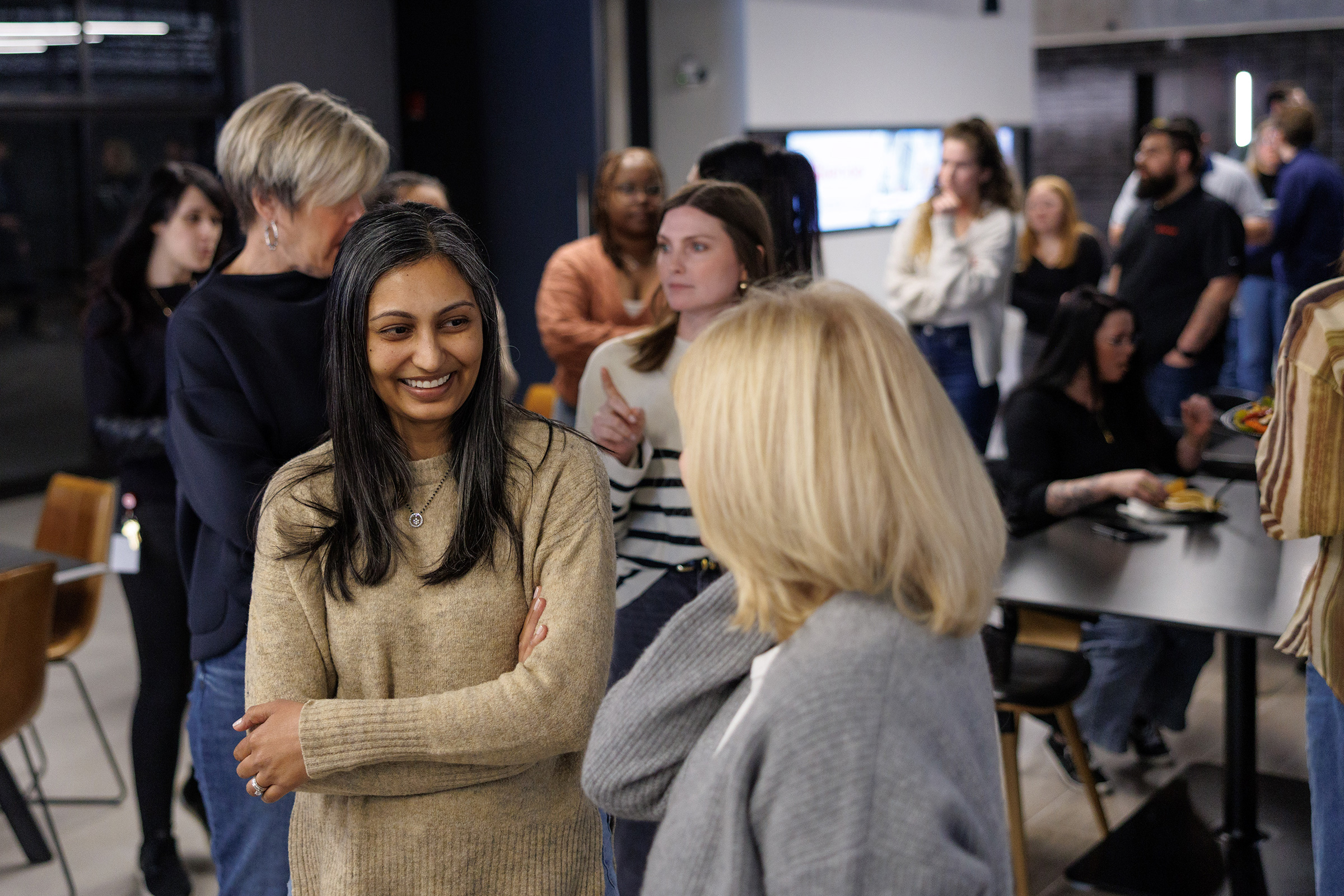 Skender team members having a conversation in the Skender office.